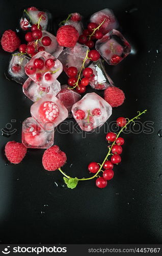 Frozen berries on wooden table. Fresh frozen berries raspberry and red currant