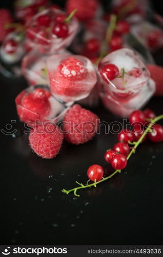 Frozen berries on wooden table. Fresh frozen berries raspberry and red currant