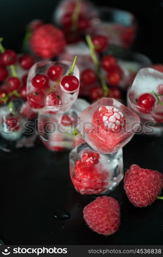 Frozen berries on wooden table. Fresh frozen berries raspberry and red currant