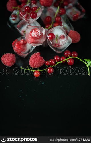 Frozen berries on wooden table. Fresh frozen berries raspberry and red currant