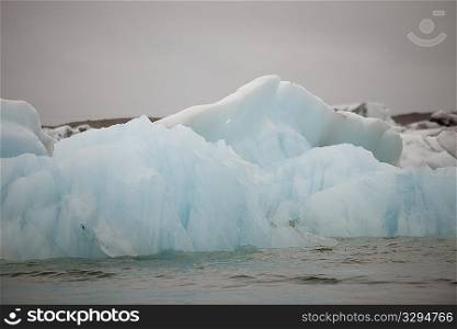 Frozen blue icebergs in a glacial lake