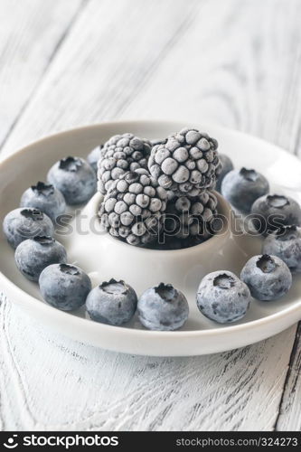 Frozen blueberries and blackberries on the plate