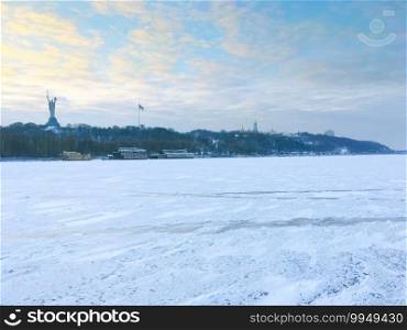 Frozen Dnipro river. Mother Motherland monument, Pechersk Lavra in the background. Kyiv, Ukraine