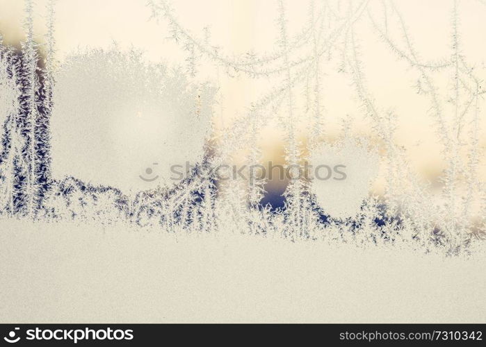 Frozen ice on a window in the sunrise on a December morning