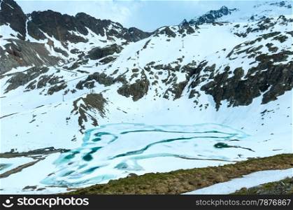Frozen lake in summer Alps mountain (Austria).