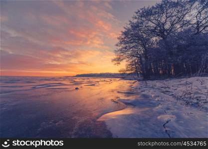 Frozen lake scenery in the sunrise at wintertime