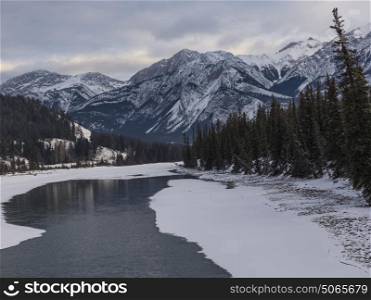 Frozen lake with mountain range in the background, Maligne Lake, Highway 16, Yellowhead Highway, Jasper, Jasper National Park, Alberta, Canada