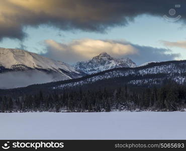 Frozen lake with snowcapped mountain range in the background, Pyramid Lake, Highway 16, Jasper, Jasper National Park, Alberta, Canada