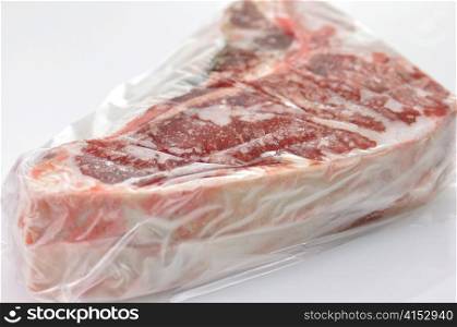 frozen meat wrapped in plastic