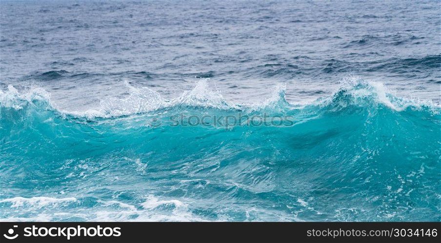 Frozen motion of ocean waves off Hawaii. Cresting ocean waves frozen with high shutter speed to show the individual droplets of water in the surf. Frozen motion of ocean waves off Hawaii
