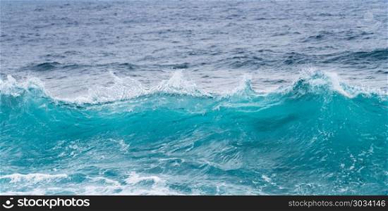 Frozen motion of ocean waves off Hawaii. Cresting ocean waves frozen with high shutter speed to show the individual droplets of water in the surf. Frozen motion of ocean waves off Hawaii