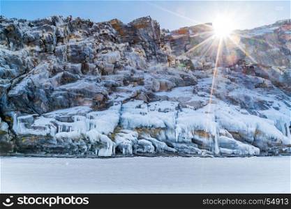 Frozen rock island with icicles in Lake Baikal, Russia