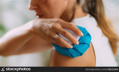 Frozen Shoulder. Woman Holding Cold Compress, Ice Bag Pack on her Painful Shoulder