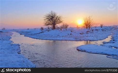 frozen sunset over winter river