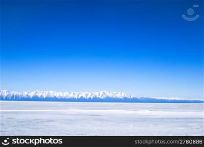 frozen winter Baikal, far mountains in background