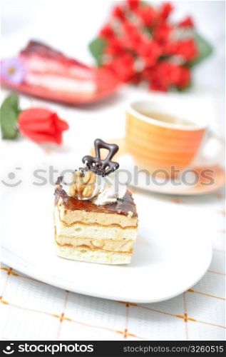 Fruit and chocolate dessert with tea, roses and napkin in red concept