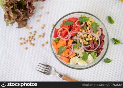 Fruit and vegetable salad in a glass cup on a white ground. Selective foucs