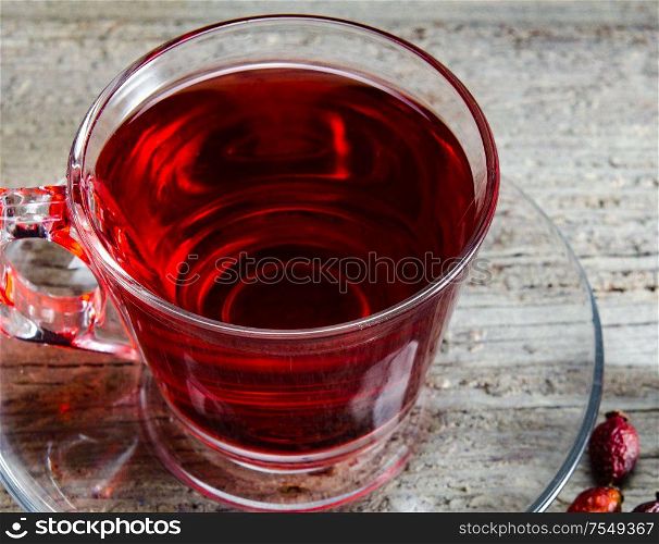 Fruit berry tea in the cup served on table. The fruit berry tea in the cup served on table