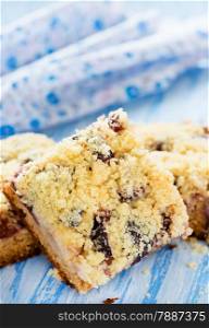 Fruit cake with streusel on blue background, selective focus