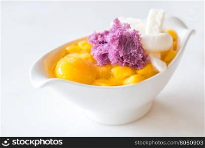 Fruit dessert with mango in white cup