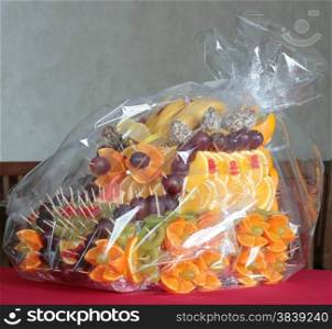 Fruit dessert with slices of citrus and berries packed in polyethylene