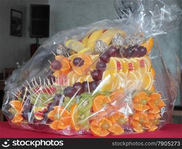 Fruit dessert with slices of citrus and berries packed in polyethylene