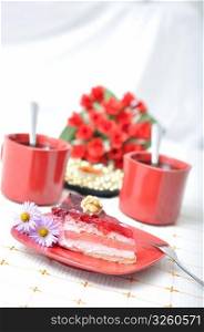 Fruit dessert with tea, red roses and napkin in red concept