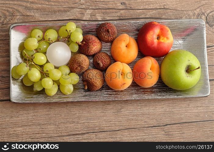 Fruit displayed on a silver plate to be used as a center piece on a table