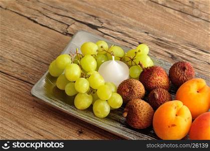 Fruit displayed on a silver plate to be used as a center piece on a table