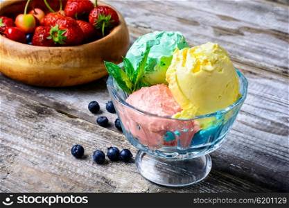 fruit ice cream. Bowl with fruit ice cream scattered on background of blueberries