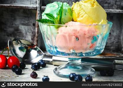 fruit ice cream. fruit ice cream scattered on background of blueberries