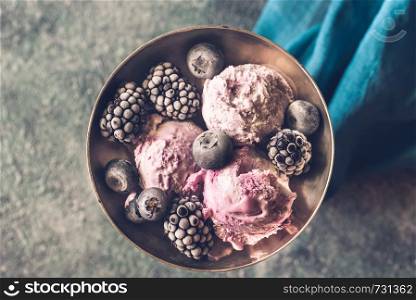 Fruit ice-cream with fresh blueberries and blackberries in vintage vase