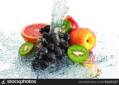 fruit in a spray of water isolated on a white background.