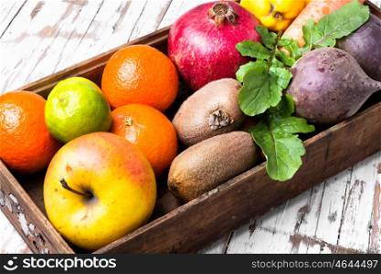 fruit in a wooden box. Box with apple, tangerine, lime and pomegranate.Dieting,detox and vegetarian