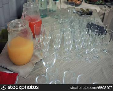fruit juice and glasses. orange and pineapple fruit juice and glasses on a table at a party