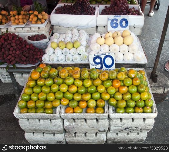 fruit market in bangkok Thailand with mangos and apples