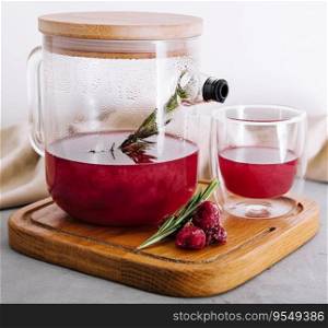 fruit raspberry tea in glass teapot and cup