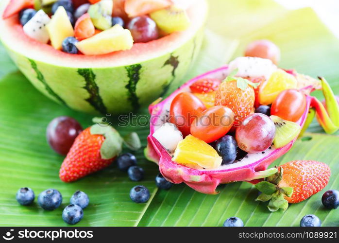 Fruit salad bowl served in a dragon fruit and watermelon vegetables healthy food strawberries orange kiwi blueberries grape pineapple tomato lemon fresh summer fruits tropical on banana leaf