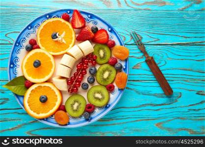 Fruit salad breakfast orange banana kiwi berries ow turquoise table