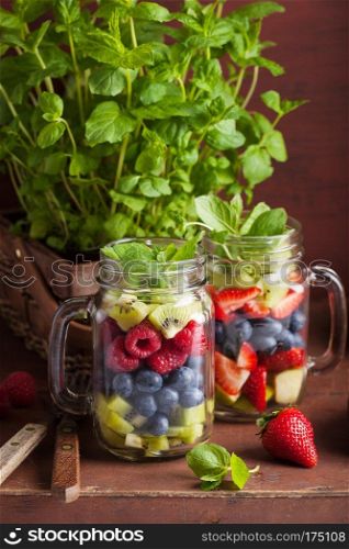 fruit salad in mason jar strawberry blueberry kiwi apple mint