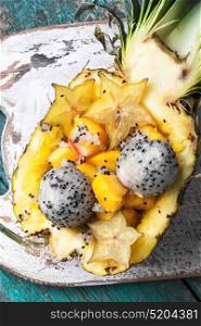 Fruit salad in pineapple. Exotic fruit salad of tropical fruit in pineapple