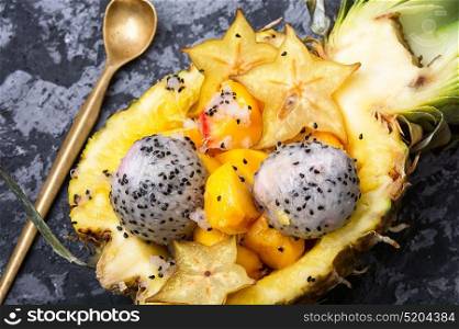 Fruit salad in pineapple. Exotic fruit salad of tropical fruit in pineapple