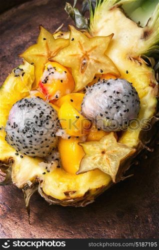 Fruit salad in pineapple. Vegetarian food.Exotic fruit salad of tropical fruit in pineapple