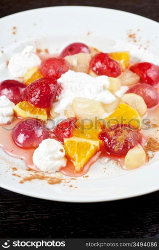 fruit salad of pineapple, grape, orange and strawberry with whipped cream