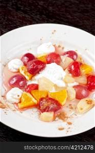 fruit salad of pineapple, grape, orange and strawberry with whipped cream