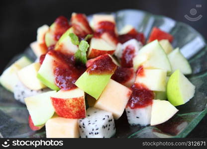 fruit salad on wood background