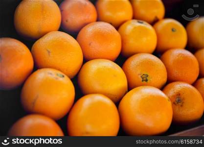 fruit, sale and food concept - oranges at street market