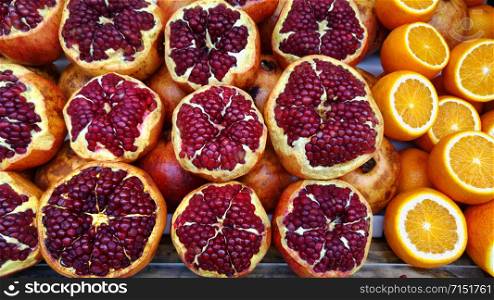 Fruit still life of pomegranates and oranges. Fresh and juicy fruits.