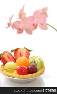 Fruit tart and Orchid on white