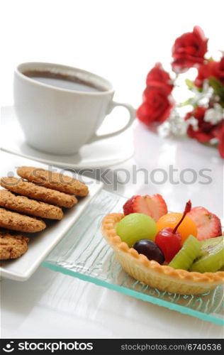 Fruit tart, cookies ,coffee and rose